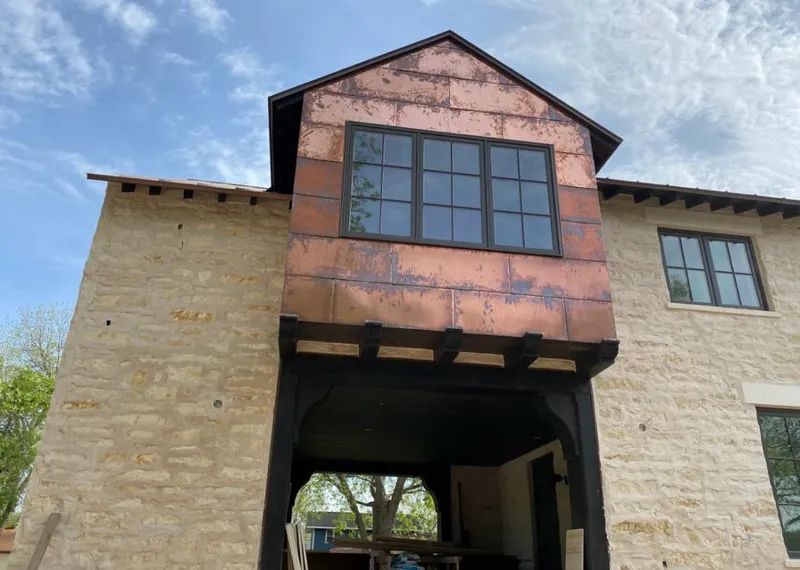 Copper metal panel facade on a stone building for Skylight Installation in Owensboro