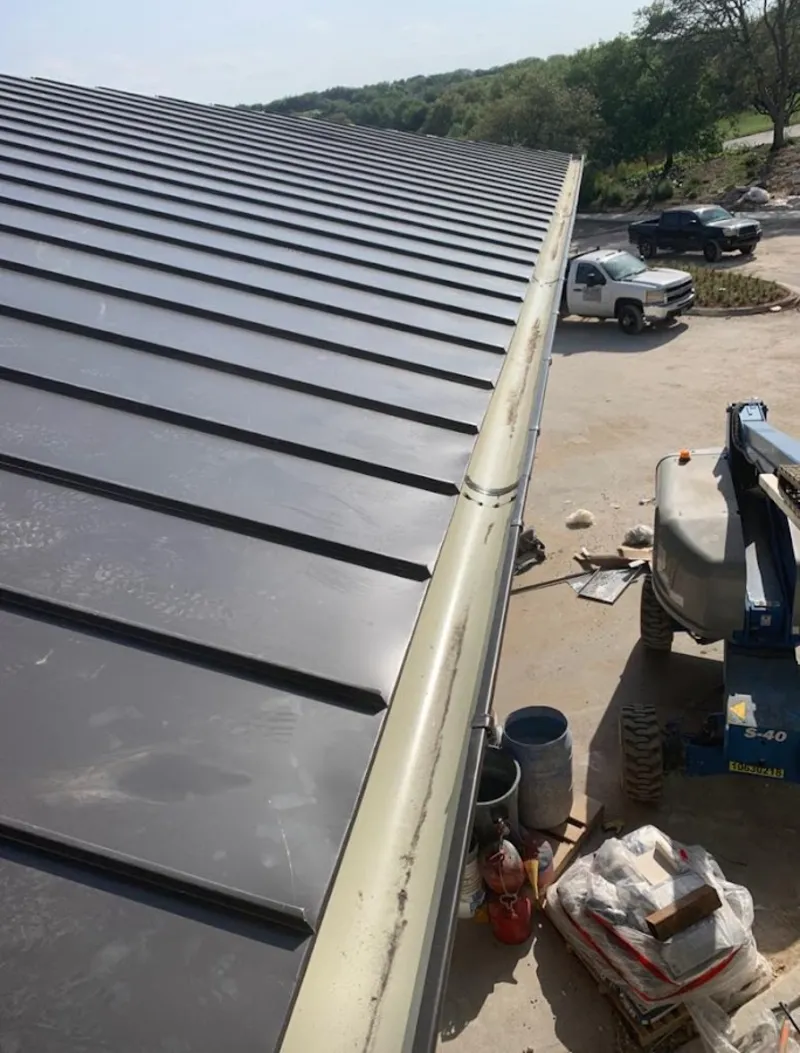 Standing seam panel and gutter detail on a metal roofing jobsite in Owensboro